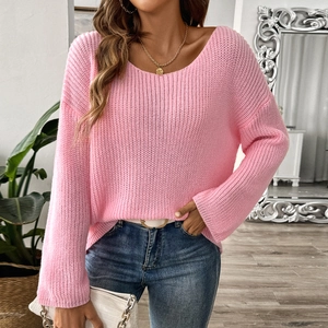 Detailed knit texture of pink off-shoulder sweater with loose flare sleeves