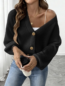 Chic black knitted cardigan for women featuring decorative vintage gold buttons and texture