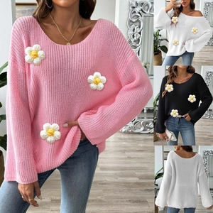 Detail of 3D crochet daisy flowers on wide-neck off-shoulder knit sweater with bell sleeves