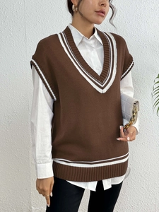 Detail of V-neck knitted vest with college style contrast stripes on neckline and armholes