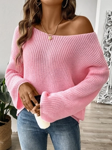 Detailed knit texture of pink off-the-shoulder sweater with stylish flared sleeve design