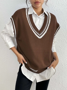 Close-up of contrast stripe trim on V-neck sweater vest with soft knit texture