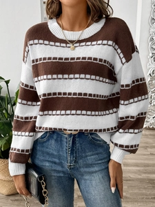 Close-up of brown and cream striped knit sweater with ribbed cuffs and soft texture