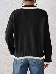 Women's black pullover knit sweater with floral embroidery and white striped ribbed trim
