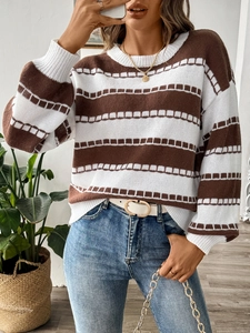 Detail of the brown and white striped knit sweater with ribbed cuffs and crew neckline