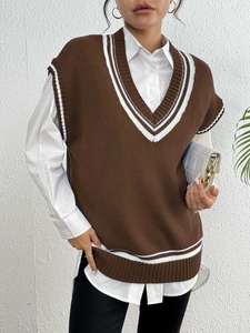 Close-up of the V-neckline detail with white stripes on a brown knit sweater vest