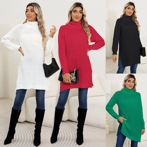 Detail view of ribbed knit texture and side slit on the oversized turtleneck sweater dress