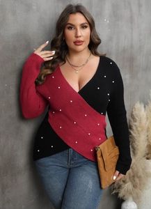 Close-up of deep V-neck wrap sweater with bicolor stitching and white pearl embellishments