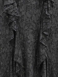 Close-up of intricate black floral lace fabric with layered ruffle details and textures