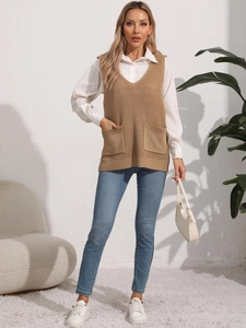 Detail of camel V-neck knit sweater vest featuring dual front pockets and rib texture