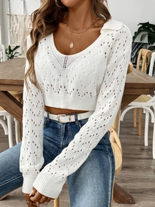 Close-up of the delicate hollow pointelle knit texture and polo collar on white cropped sweater