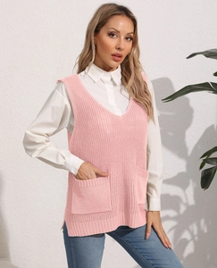 Detailed close-up of a pink knit vest with V-neck and pockets over a white shirt