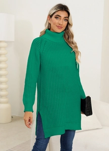Detail of emerald green knit sweater featuring a turtle neck and side split hem design