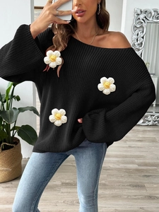 Women's off-shoulder black knit sweater with oversized white 3D floral appliqués
