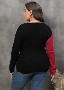 Detail of knit sweater showing black and magenta color blocking on the back and sleeve