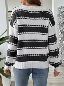 Back view of women's black and white striped knit sweater with ribbed cuffs and hemline