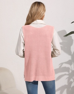 Detail of pink knitted vest back texture worn over white shirt and blue jeans