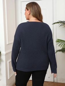Rear view of oversized navy blue rib-knit sweater showing drape and loose fit design