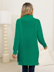 Detail view of emerald green knit sweater dress with side slit and ribbed texture on back
