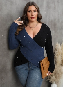 Detail of V-neck cross sweater with contrast patchwork and white bead embellishments