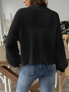 Back view of black chunky knit cardigan with ribbed cuffs and drop shoulder detail