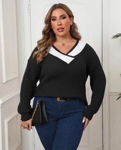 Detail of plus size V-neck sweater showing black knit texture and white contrast trim