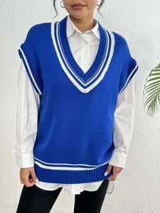Detail of royal blue V-neck knit vest with collegiate white stripes and white shirt
