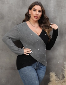 Detailed view of women's V-neck sweater featuring pearl beads and contrast stitching