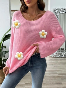 Pink knit sweater featuring 3D crochet daisy flowers and a relaxed off-shoulder fit