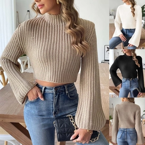 Detailed waffle knit texture on crop top sweater featuring mock neck and flare bell sleeves