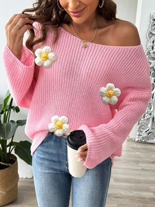 Detail of pink off-shoulder knit sweater featuring handmade 3D white crochet flowers