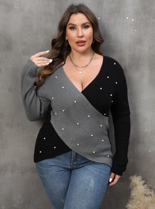 Detailed view of the V-neck wrap sweater featuring contrast panels and elegant pearl beadwork