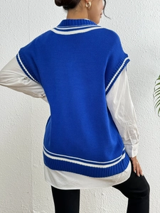 Rear view of preppy style blue knit vest with white double stripe trim on the ribbed hem