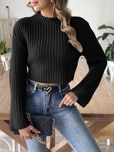 Detailed view of the black cropped knit sweater featuring trendy flared bell sleeves
