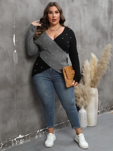Women's plus size knit sweater featuring a deep V-neck, color block design, and pearl beads