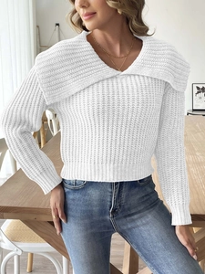 Detail of white knit sweater featuring a wide collar and thick cable texture