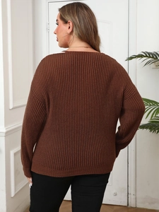 Detail showing the brown ribbed knit texture and dropped shoulders on a loose V-neck sweater