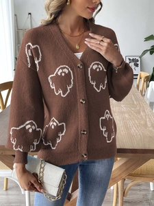 Detail of V-neck brown knit cardigan featuring white ghost patterns and button closure