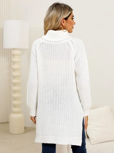Detail shot of white turtleneck knit sweater with side slits and textured waffle knit