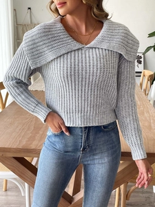 Detail of grey chunky knit sweater featuring a stylish oversized collar and soft texture