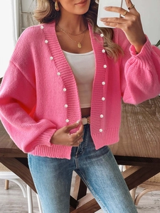 Women's bright pink knit cardigan featuring elegant white pearl bead accents and loose fit
