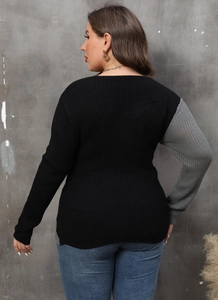 Detail of color-block knit sweater showing back-side view of black and grey contrast sleeves