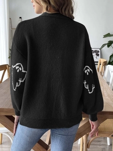 Close-up of the ghost motif on sleeves and ribbed cuffs of this black Halloween cardigan