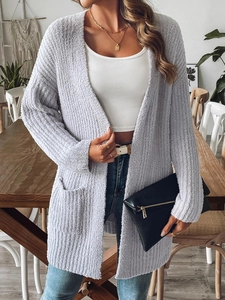 Detail showing the lavender fuzzy knit texture and functional pockets on a cozy cardigan