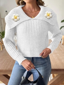 Women's white chunky knit sweater featuring large lapel collar and handmade floral patches