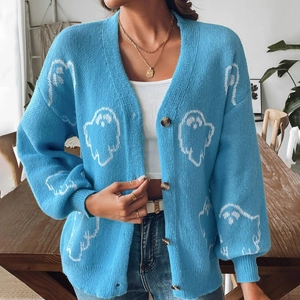 Detail of light blue Halloween cardigan featuring white ghost patterns and vintage buttons