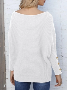 Detail view of white batwing sleeve sweater with gold button decor on cuffs
