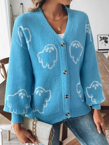 Detail of blue Halloween cardigan with white ghost patterns and amber buttons