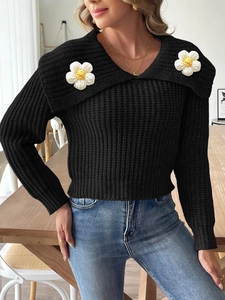 Women's black knit crop sweater with 3D white daisy crochet flowers and V-neckline