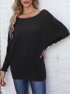 Detail of batwing sleeves with golden pearl decorative buttons on dark grey sweater
